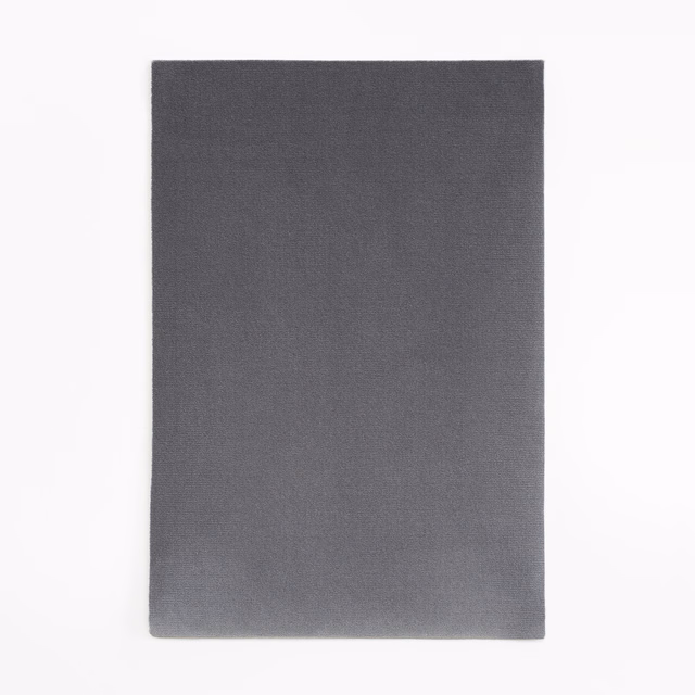 Smooth anthracite velvet with a subtly light-catching pile and charcoal-grey surface