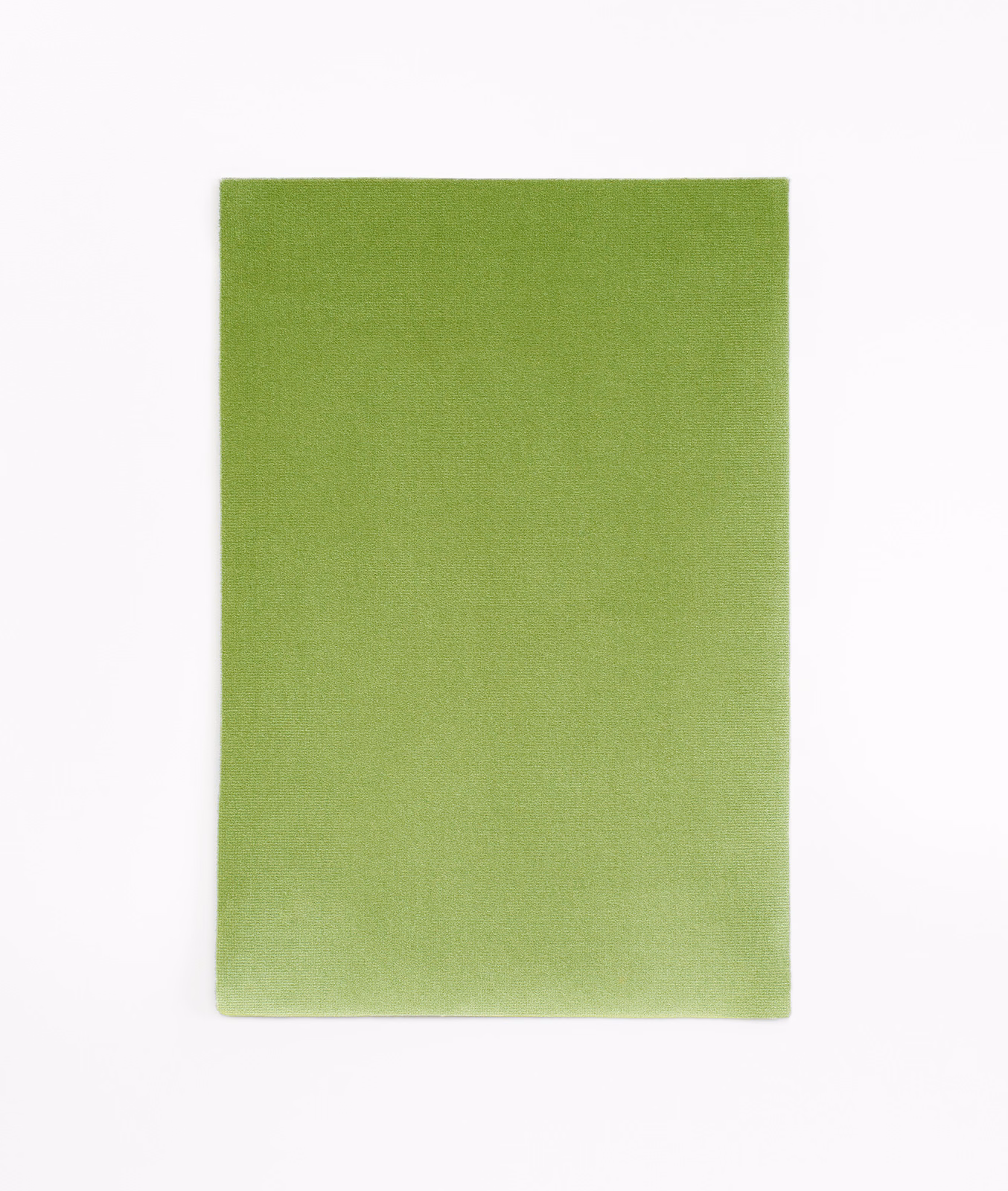 Fresh apple-green velvet swatch with subtle nap shading across its plain surface