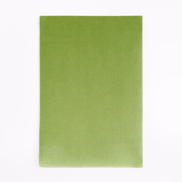 Fresh apple-green velvet swatch with subtle nap shading across its plain surface