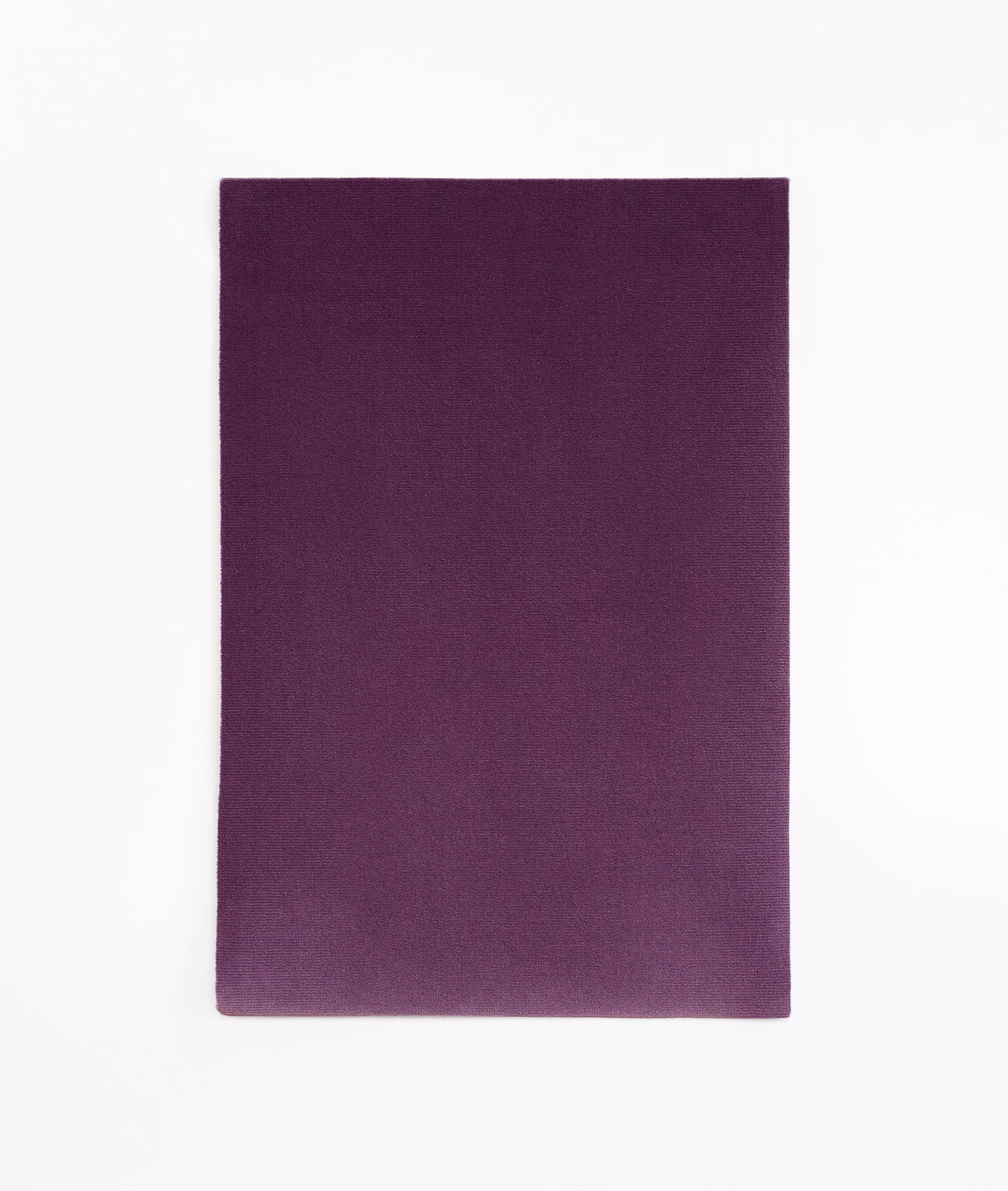 Deep aubergine-purple velvet swatch with a subtle, softly light-catching nap