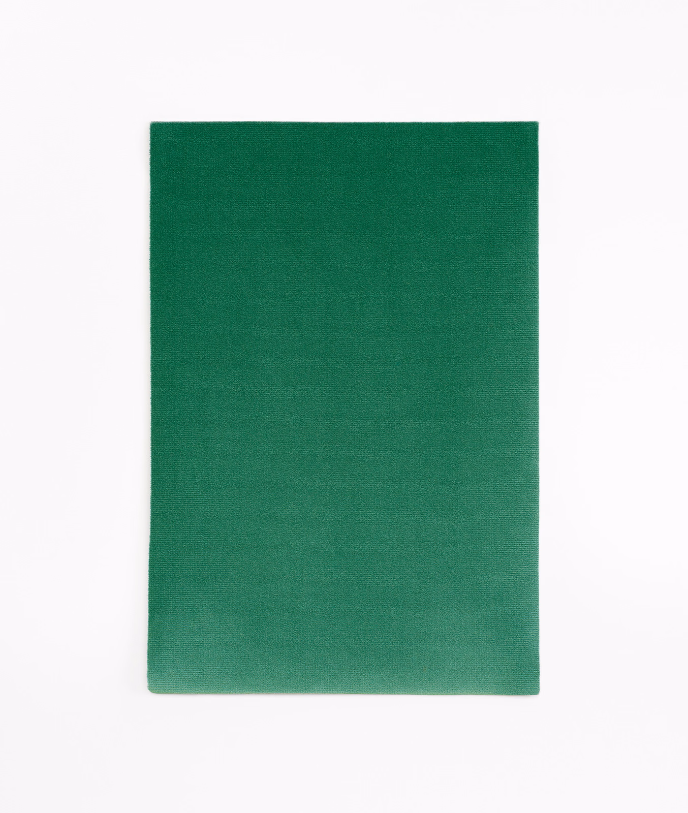 Saturated forest green velvet swatch with subtle tonal nap variation across its plain surface