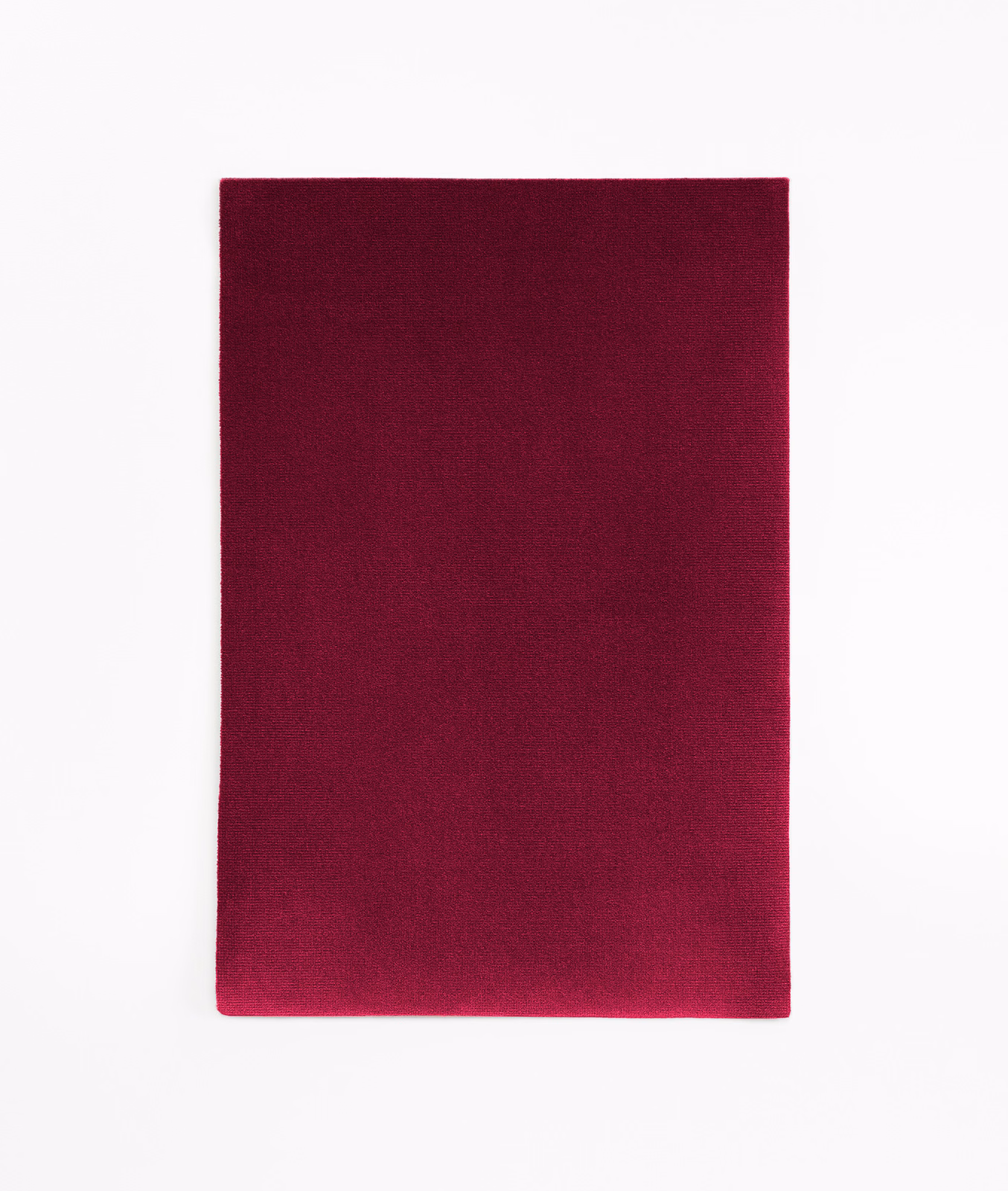 Deep aubergine velvet swatch with softly shifting pile and darker edges