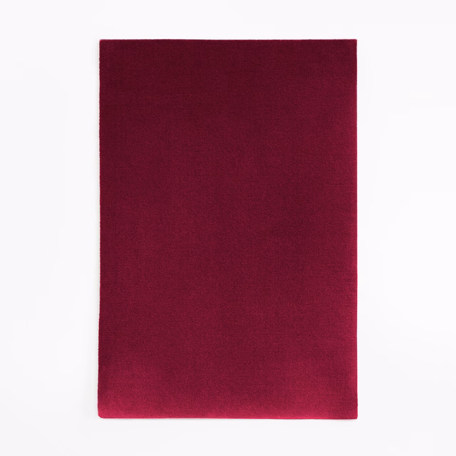 Deep aubergine velvet swatch with softly shifting pile and darker edges