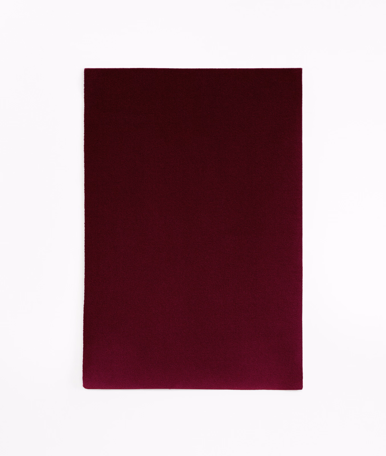 Deep plum burgundy velvet swatch showing a smooth, subtly light-catching pile