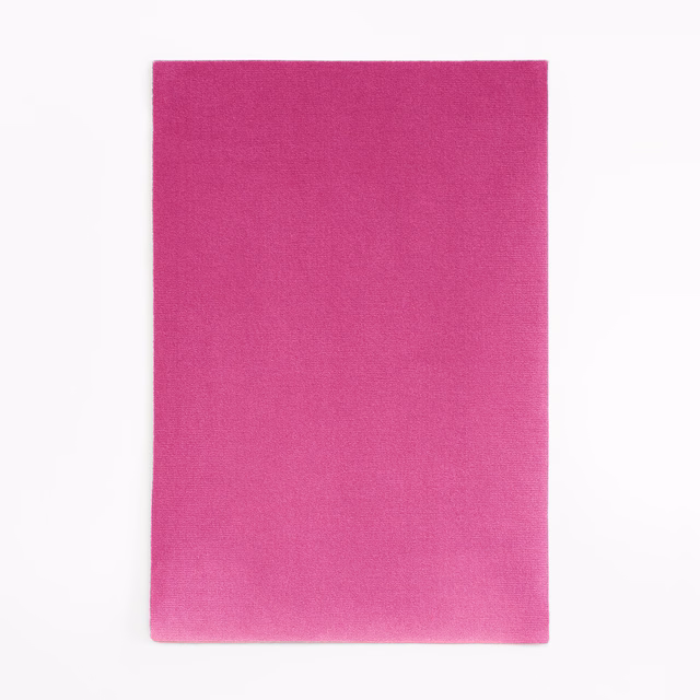 Close-up of vivid shocking magenta pink velvet with a soft, subtly brushed surface
