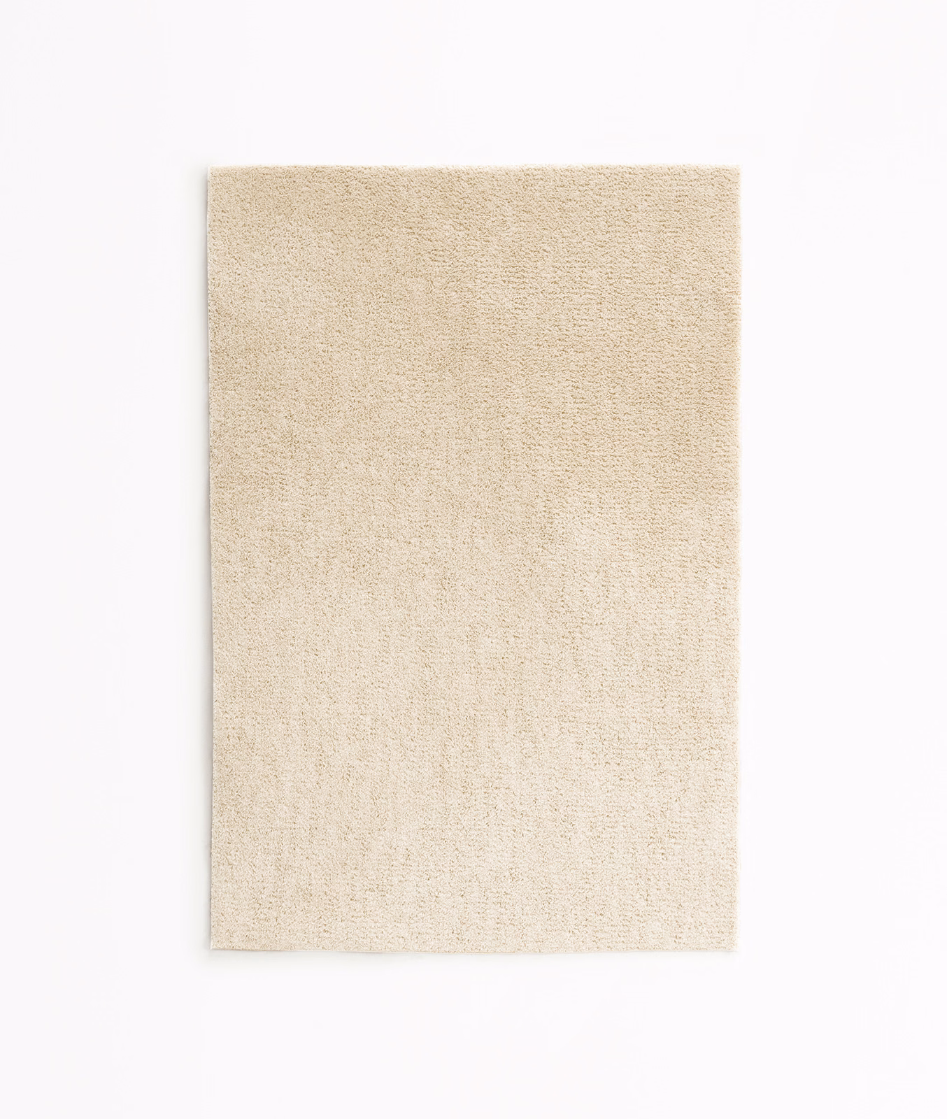 Warm ivory velvet swatch with a softly mottled short pile and subtle cream shading