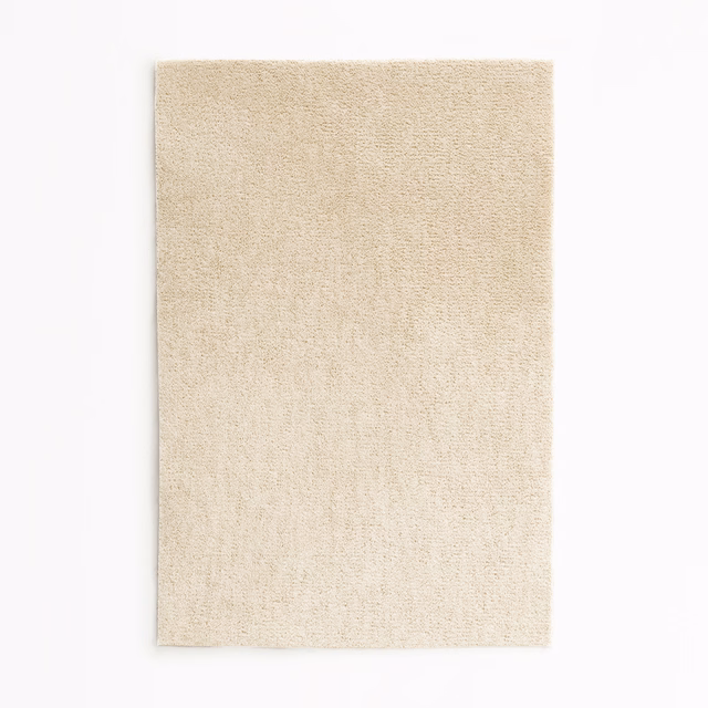 Warm ivory velvet swatch with a softly mottled short pile and subtle cream shading