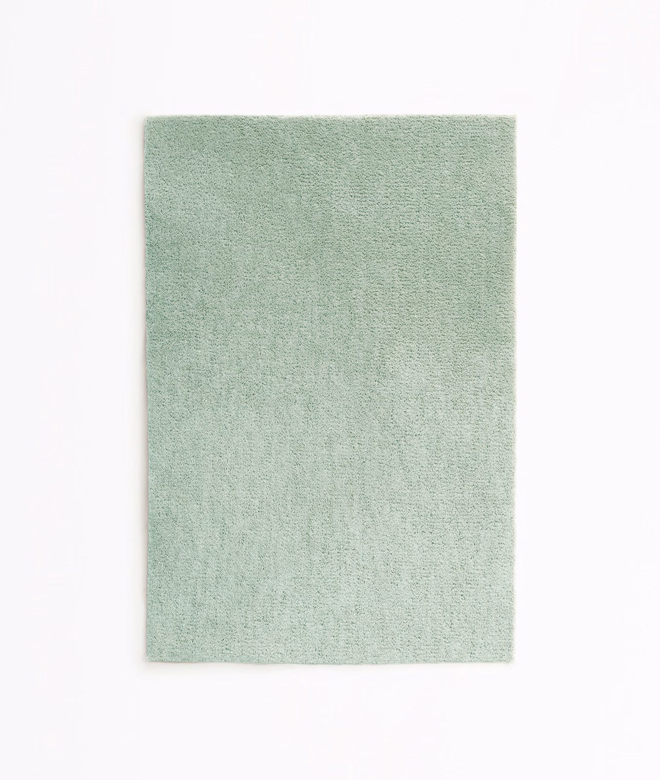 Pale celadon green velvet swatch with a softly mottled, fine-textured pile