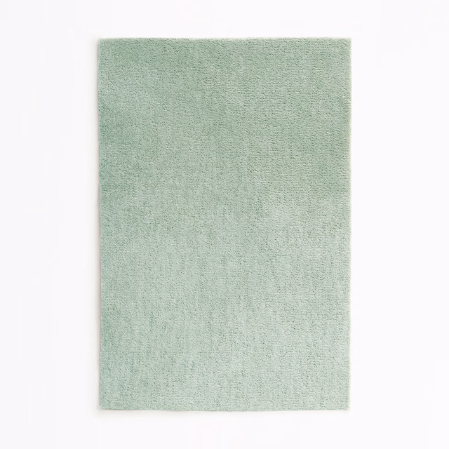 Pale celadon green velvet swatch with a softly mottled, fine-textured pile