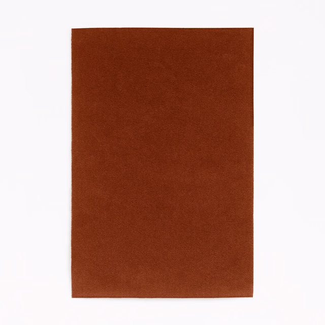 Deep brick-terracotta velvet swatch with an even, subtly light-catching pile