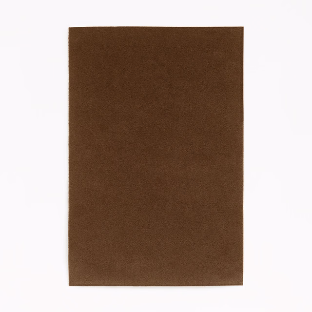 Warm tobacco-brown velvet with subtle nap shading across a plain surface