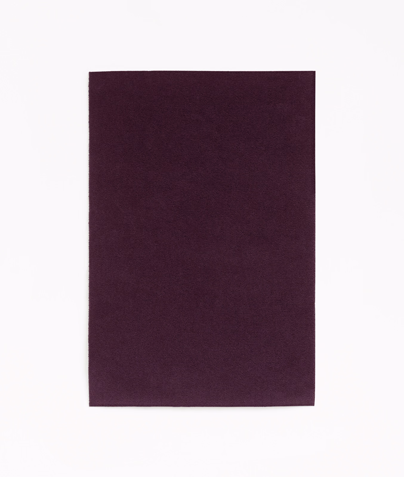 Deep plum-purple velvet swatch with subtle directional nap and softly shaded plain surface