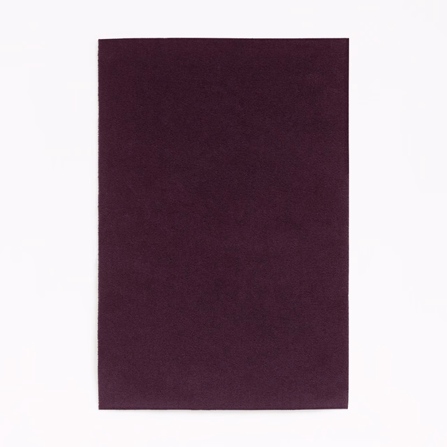 Deep plum-purple velvet swatch with subtle directional nap and softly shaded plain surface