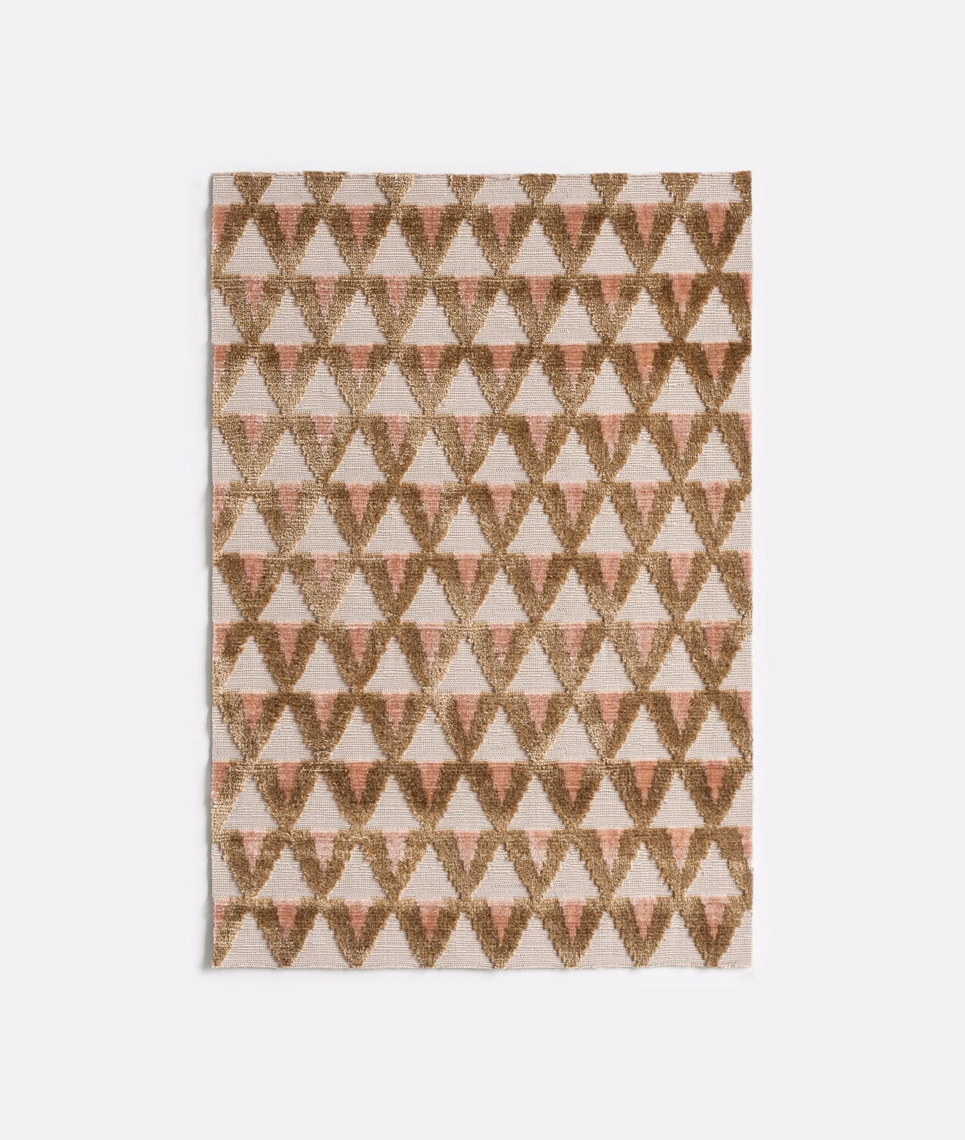 Cream velvet with amber and rose-brown repeating geometric hourglass motifs