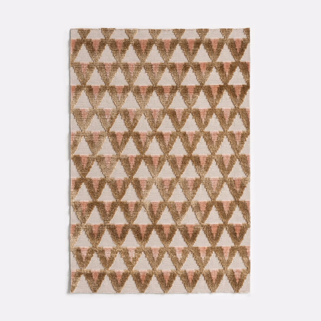 Cream velvet with amber and rose-brown repeating geometric hourglass motifs