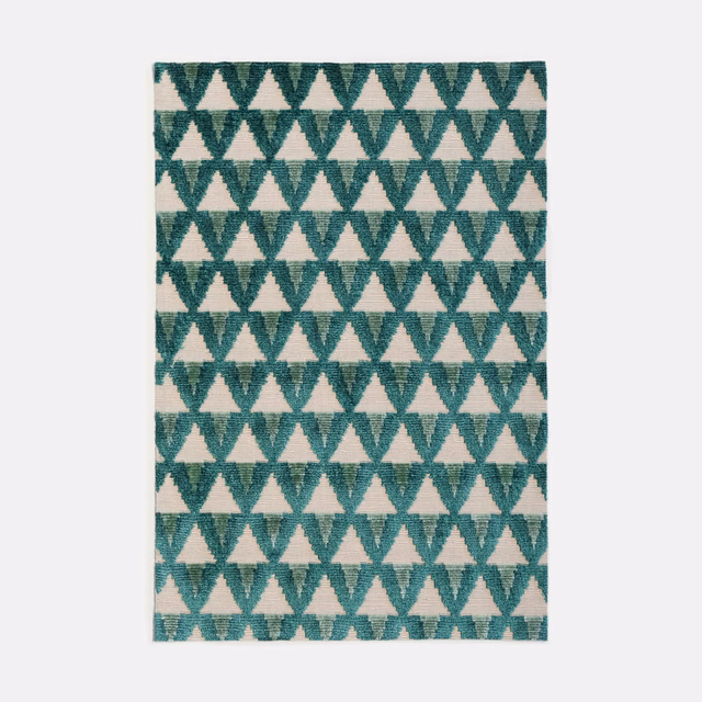 Deep malachite teal velvet with repeating cream triangles and a softly brushed surface