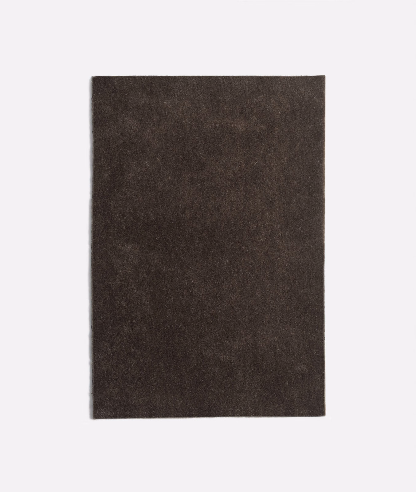 Deep charcoal-brown velvet with softly mottled nap and restrained light-catching sheen