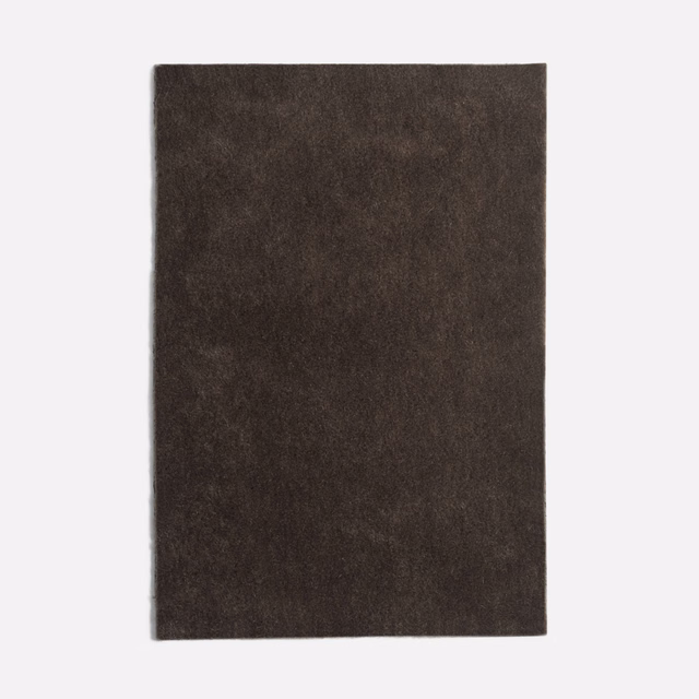 Deep charcoal-brown velvet with softly mottled nap and restrained light-catching sheen