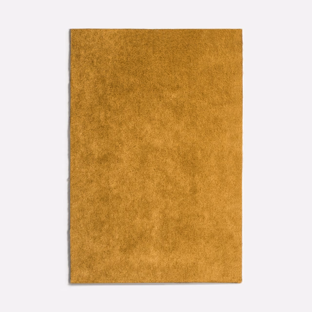 Curry-gold velvet swatch with softly mottled plush pile and warm tonal depth