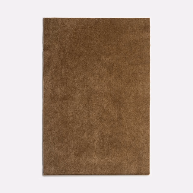 Warm tobacco-brown velvet swatch with softly mottled nap and subtle directional sheen