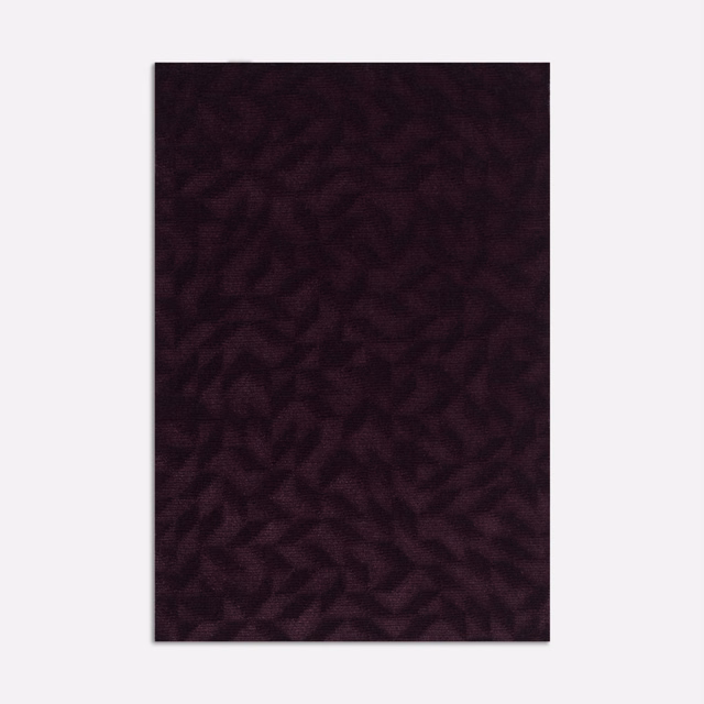 Deep plum velvet swatch with a shadowed, irregular organic pattern and soft pile