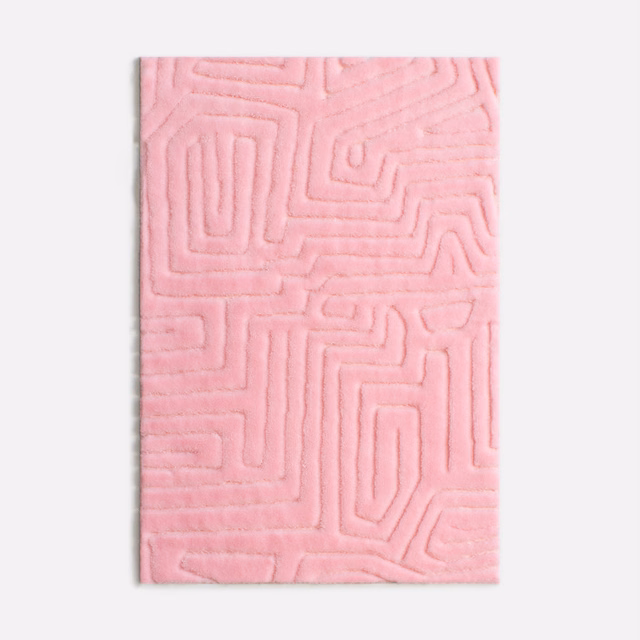 Soft flamingo-pink velvet swatch with raised maze-like linear pattern and plush nap