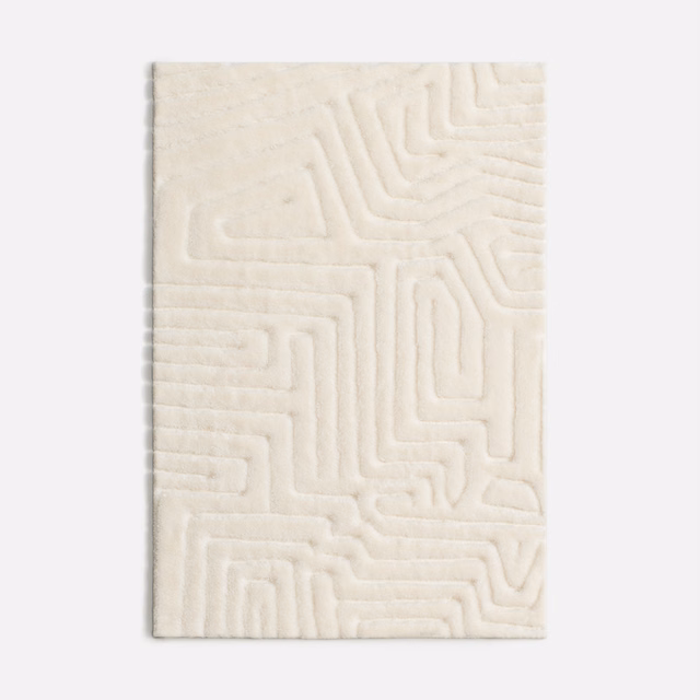 Soft ivory velvet swatch with raised maze-like geometric channels and plush shading
