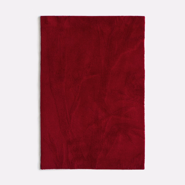 Deep burgundy velvet swatch with faint tonal botanical outlines and softly shifting pile