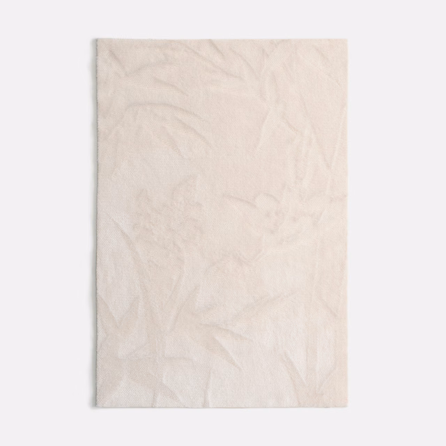 Pale ivory velvet with barely visible botanical leaves and softly shifting nap