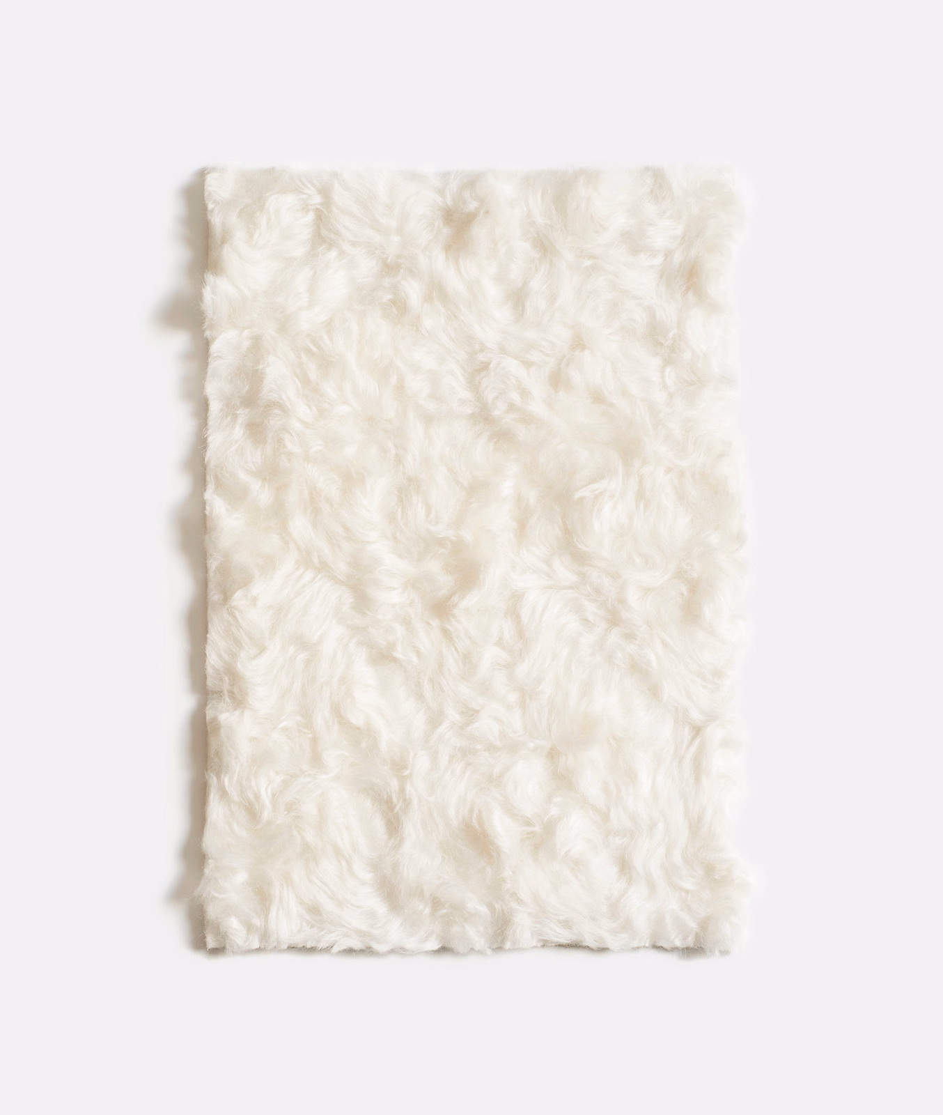 Warm ivory velvet swatch with plush curled pile and softly shadowed texture
