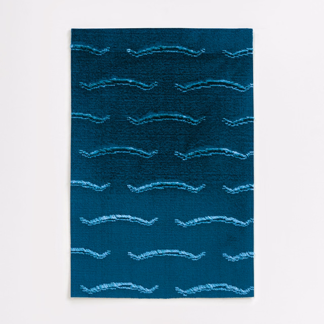 Deep lapis teal velvet with pale aqua horizontal wave motifs and a softly textured surface