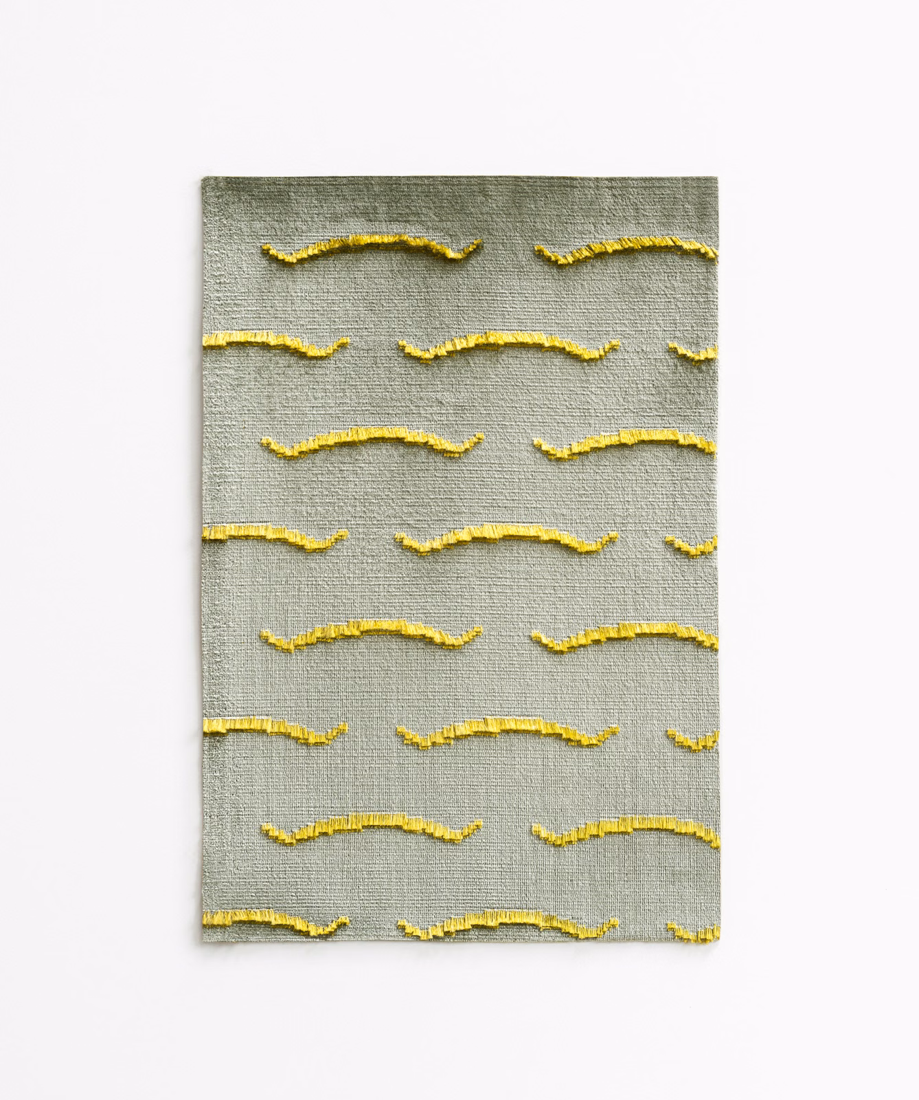 Olive-grey velvet swatch with raised golden-yellow horizontal wave motifs