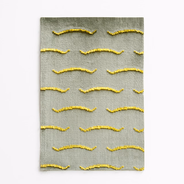 Olive-grey velvet swatch with raised golden-yellow horizontal wave motifs