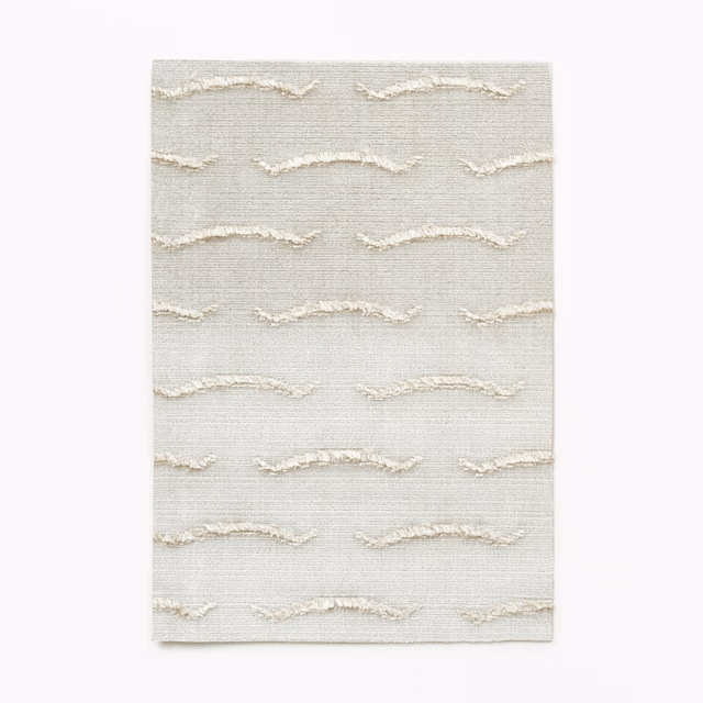 Pale pearl velvet with raised ivory wave bands and fine horizontal texture