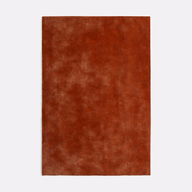 Mottled rust-red terracotta velvet with cloudy highlights across the pile