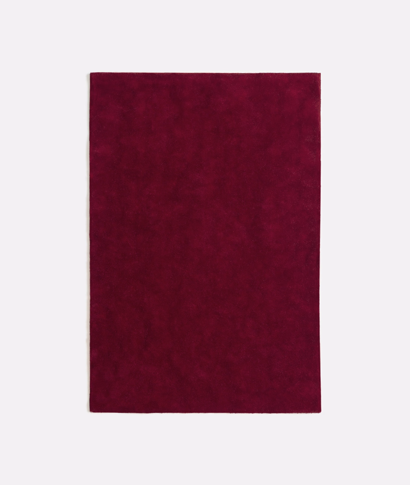 Deep bordeaux velvet swatch showing subtle nap variation across a plain surface