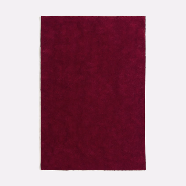 Deep bordeaux velvet swatch showing subtle nap variation across a plain surface