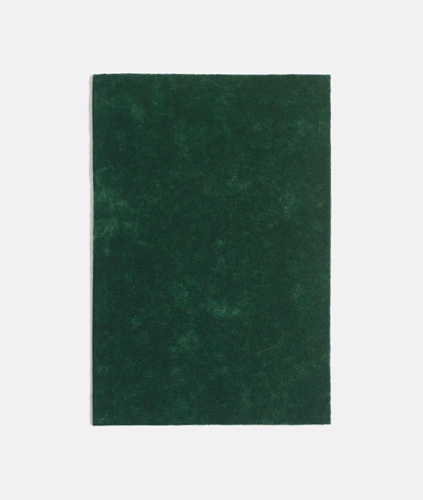 Deep forest-green velvet swatch with softly mottled nap and shifting dark highlights