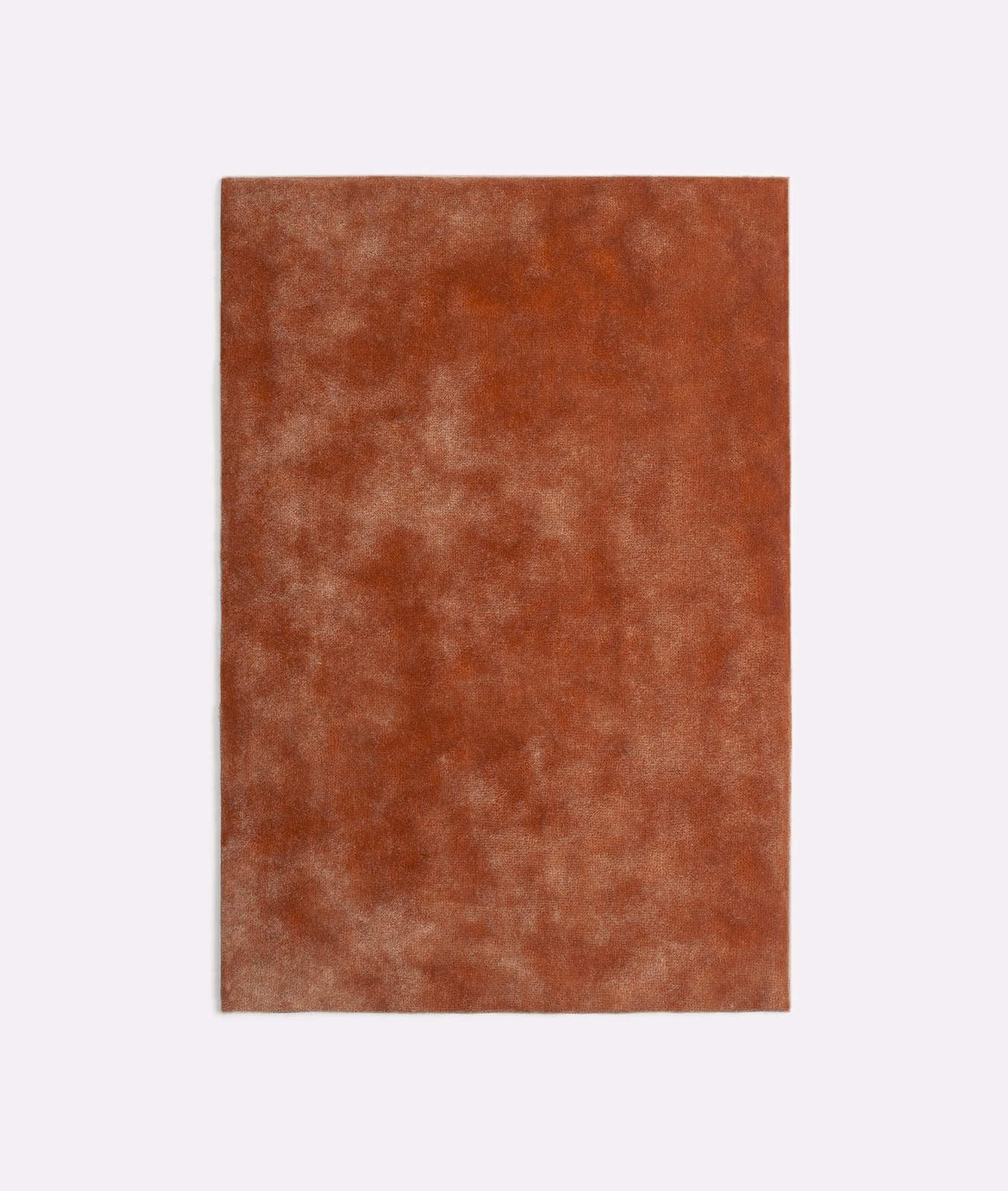 Burnished terracotta velvet swatch with cloudy rust and peachy pile variation