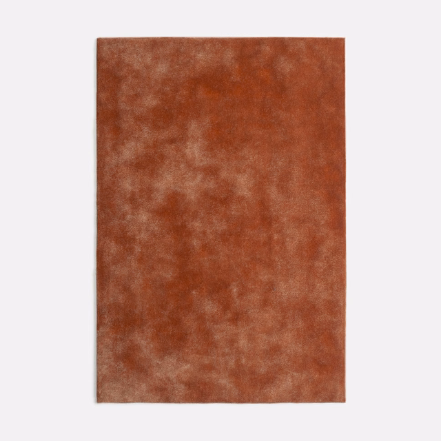 Burnished terracotta velvet swatch with cloudy rust and peachy pile variation