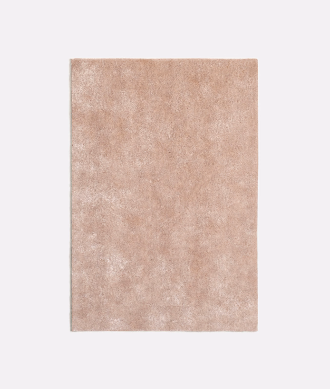 Mottled dusty blush-pink velvet swatch with a softly glowing plush nap