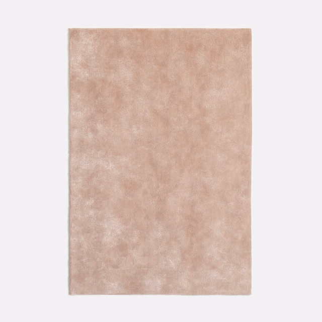 Mottled dusty blush-pink velvet swatch with a softly glowing plush nap