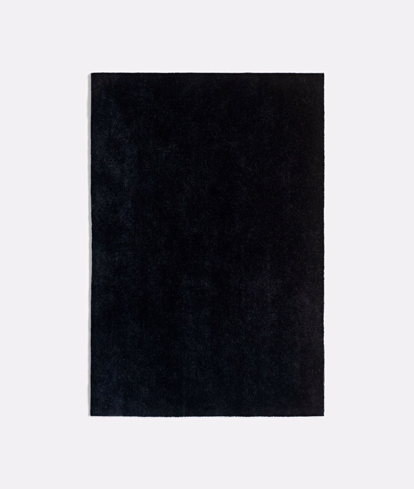 Near-black charcoal velvet swatch showing a softly shifting plush nap