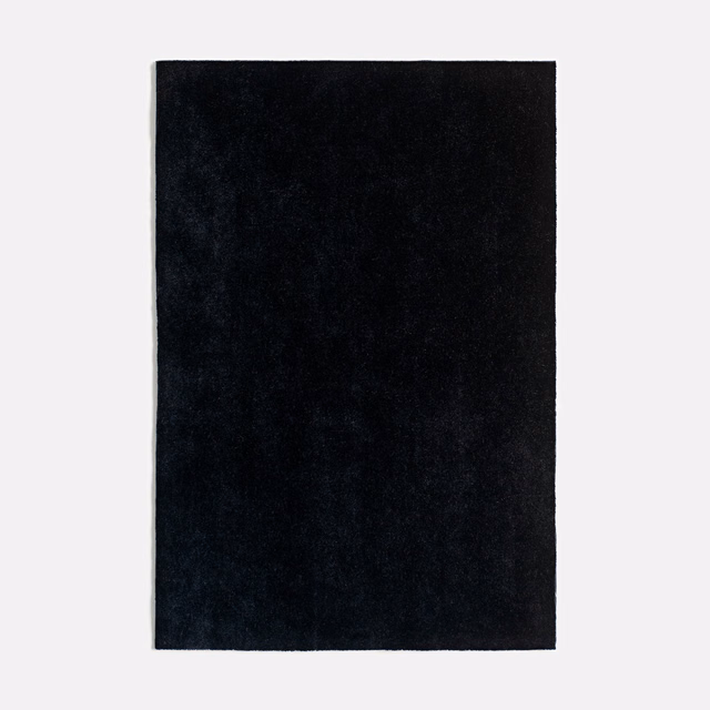 Near-black charcoal velvet swatch showing a softly shifting plush nap
