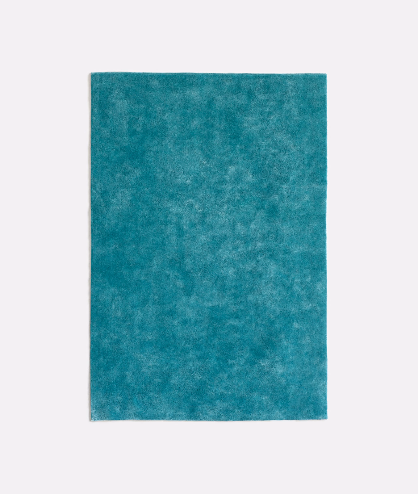 Saturated turquoise-teal velvet with cloudy mottling and a softly light-catching nap