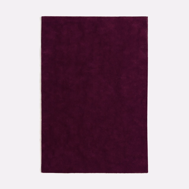 Deep plum-purple velvet swatch with subtle nap shifts and a softly mottled surface