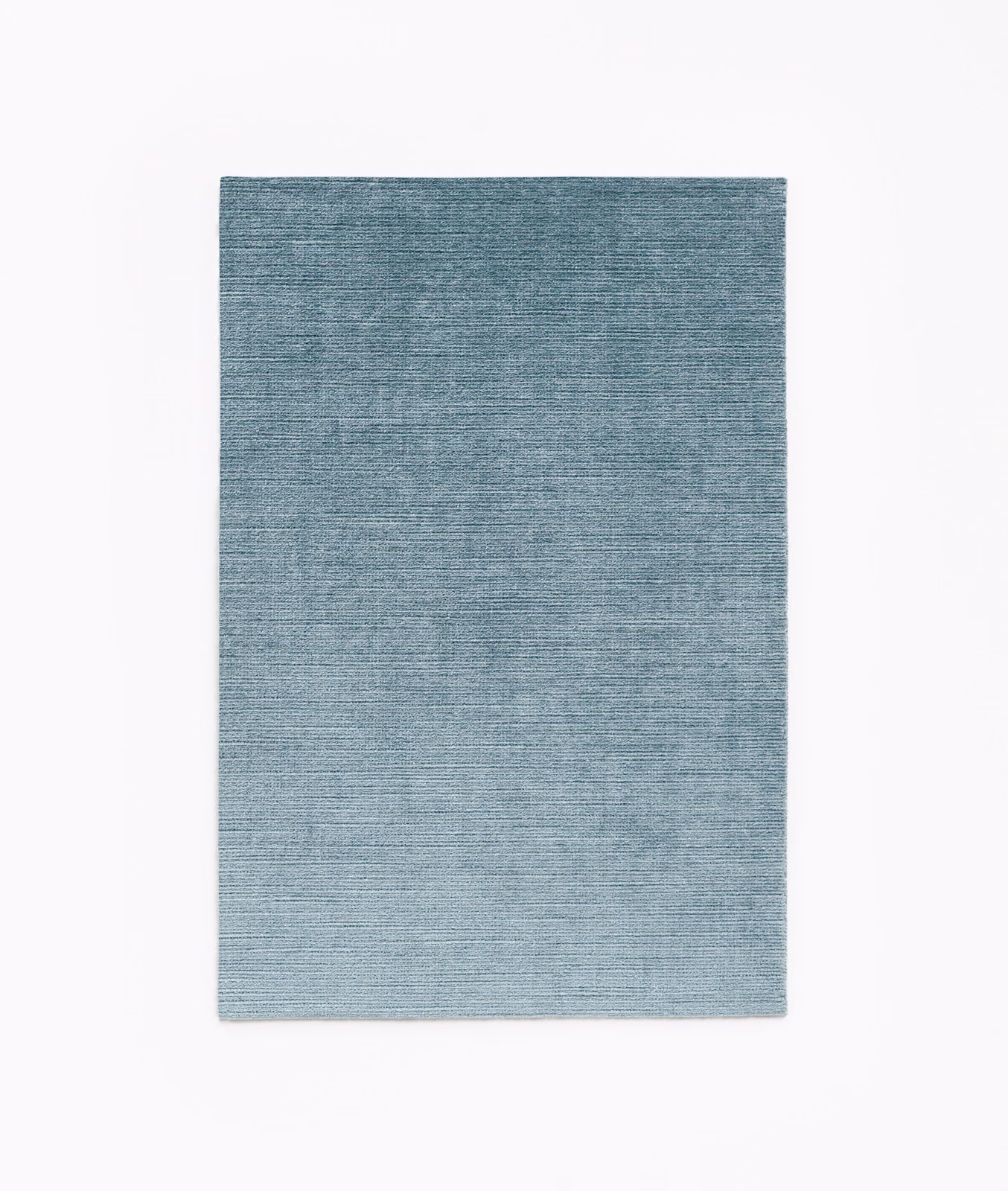 Muted blue-grey velvet swatch with fine horizontal striations and softly varied denim tones