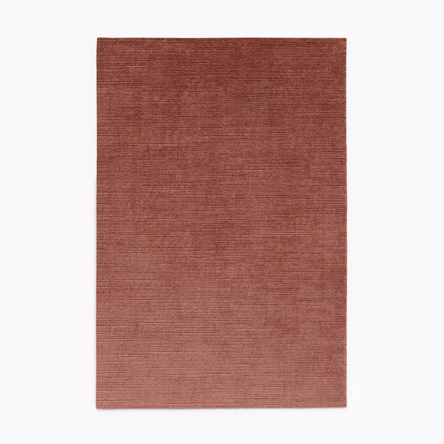 Muted brick-blush velvet swatch with fine horizontal striated texture