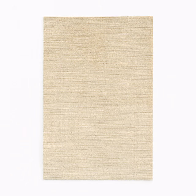 Warm ivory cream velvet swatch with fine horizontal pile lines and subtle sheen