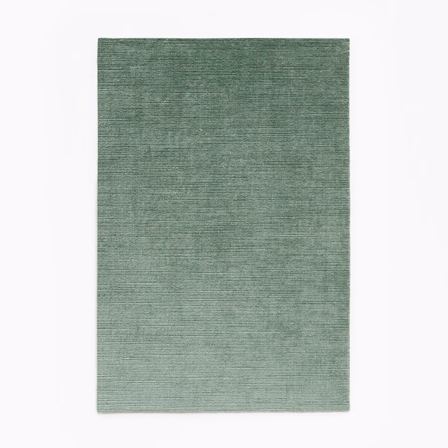 Muted celadon green velvet swatch with fine horizontal striations and softly mottled texture